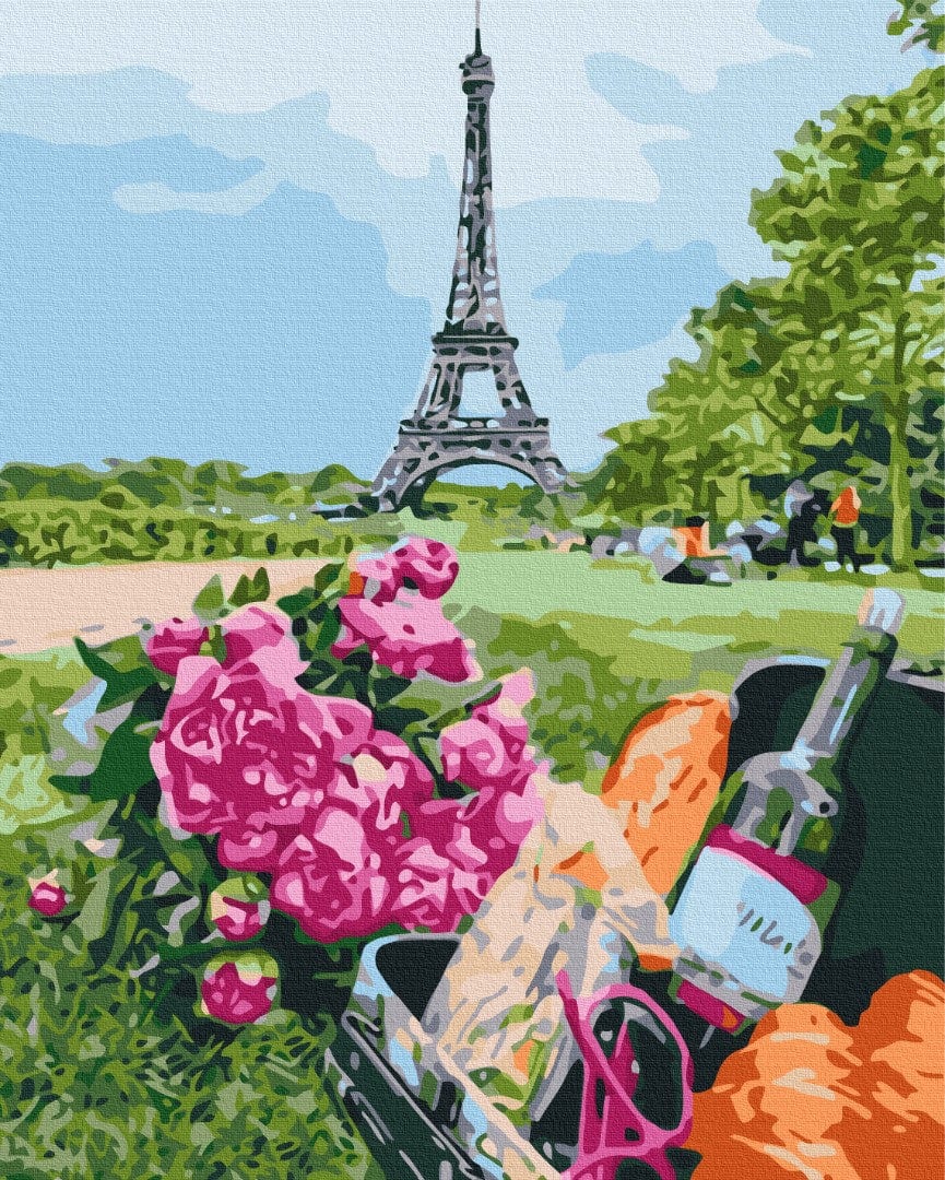 Picnic basket with baguette and wine beside pink roses, Eiffel Tower in the background