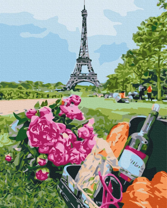 Picnic basket with baguette and wine beside pink roses, Eiffel Tower in the background