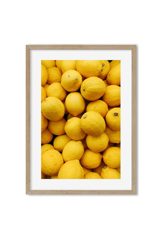 Poster of a close-up pile of bright yellow lemons filling the frame
