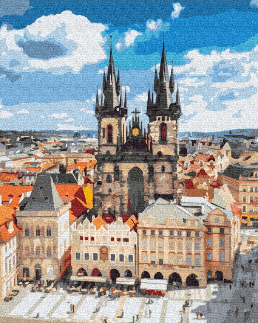 Gothic twin spires rising above Prague's Old Town Square market stalls