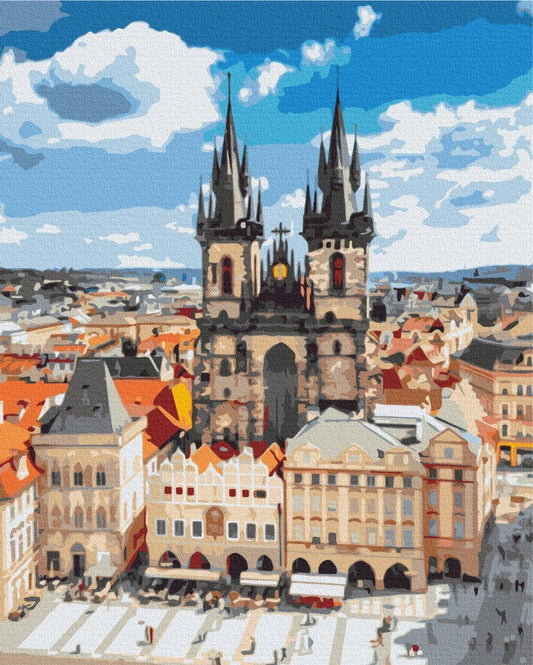Gothic twin spires rising above Prague's Old Town Square market stalls