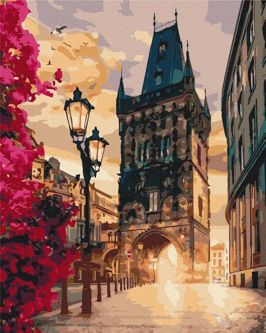 Prague Powder Tower paint-by-numbers scene at dusk with street lamps and blossoming tree.
