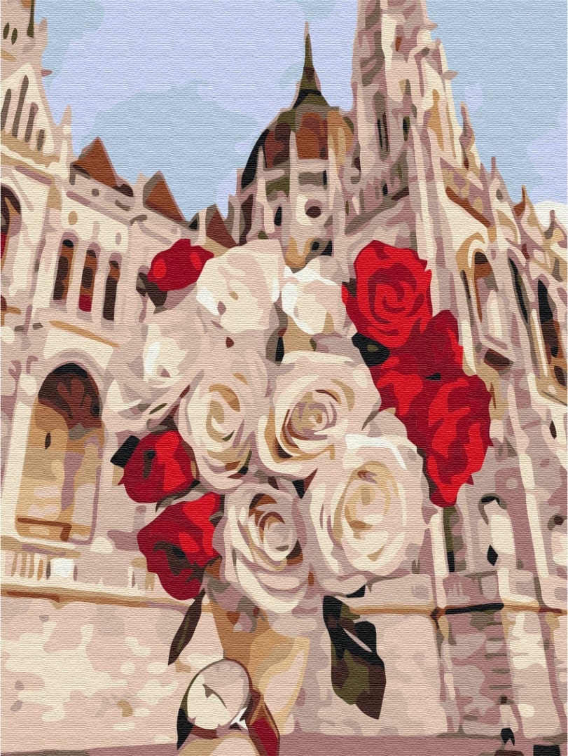 Bouquet of red and white roses against Budapest's Gothic spire and domed tower
