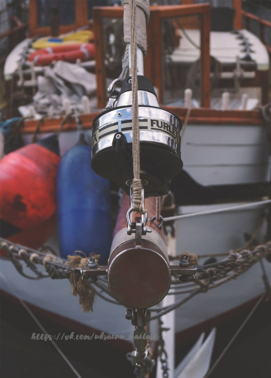 Rollreff-Trommel und Tauwerk eines Segelboots in Nahaufnahme mit Fendern im Hintergrund