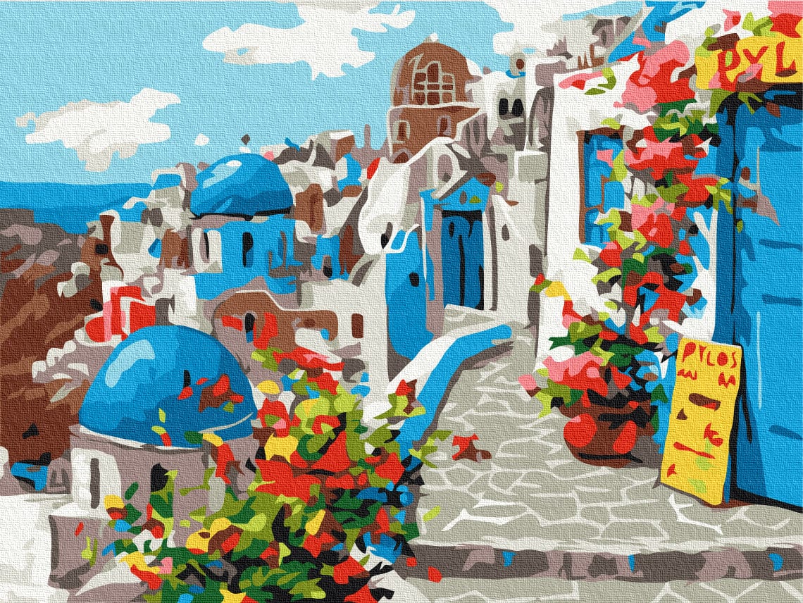 Santorini lane with blue church domes and red bougainvillea flowers spilling over a wall