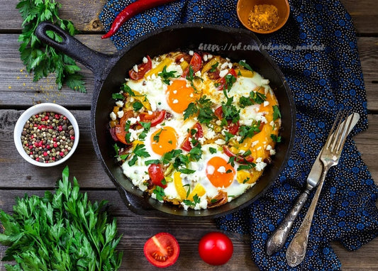 Shakshuka eggs baked in tomato sauce with feta in a cast iron skillet