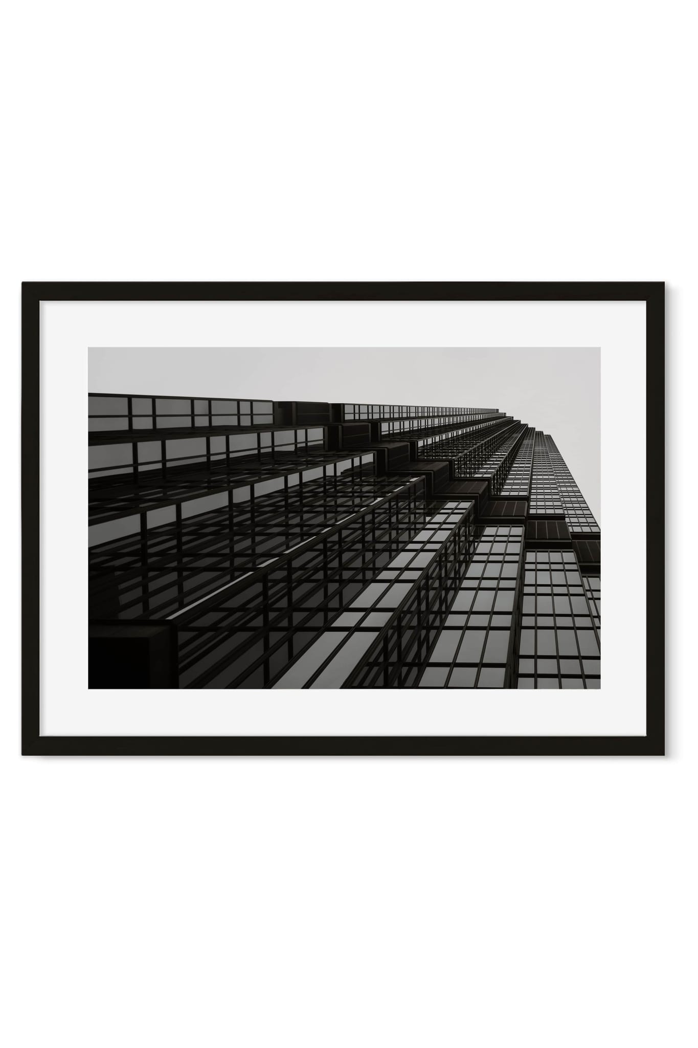 Black-and-white poster of a skyscraper facade photographed from below