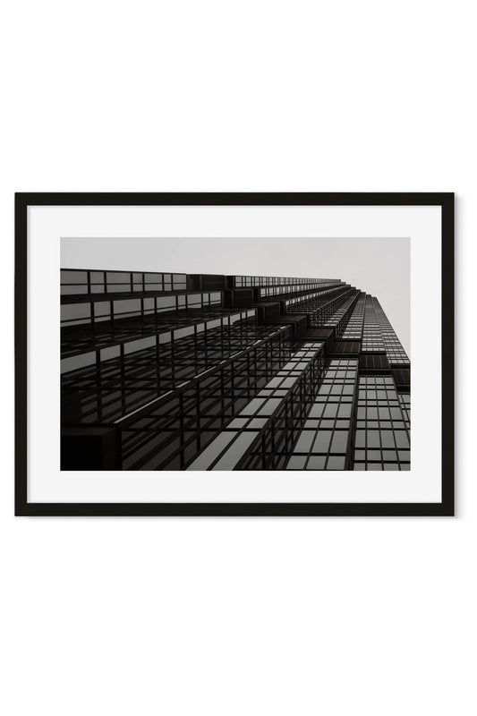 Black-and-white poster of a skyscraper facade photographed from below