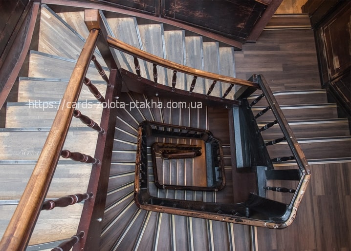 Overhead view of a spiral wooden staircase in an old Lviv building