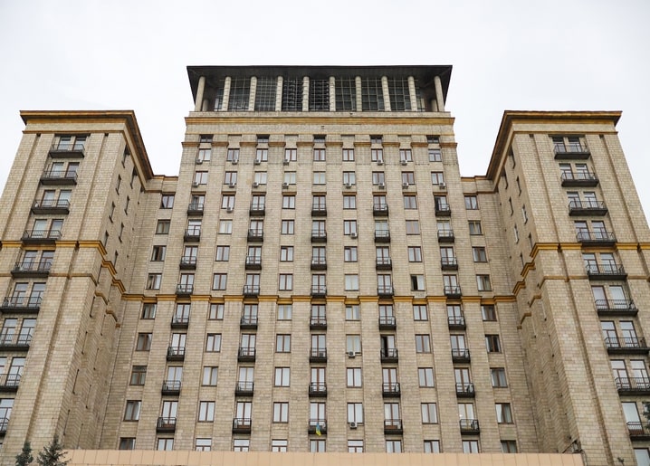 Low-angle view of a Stalin-era apartment building facade with balconies in Kyiv