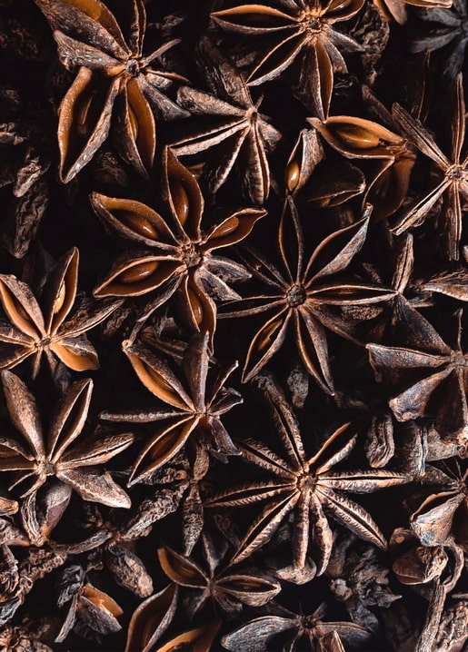 Close-up of dried star anise pods forming a warm brown winter-spice texture