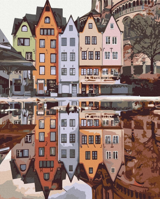 Colorful gabled townhouses in Stockholm mirrored in still water, cathedral tower behind