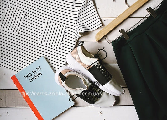 Flatlay mit gestreiftem Top, Sneakern, grüner Hose und Notizbuch „This Is My London“