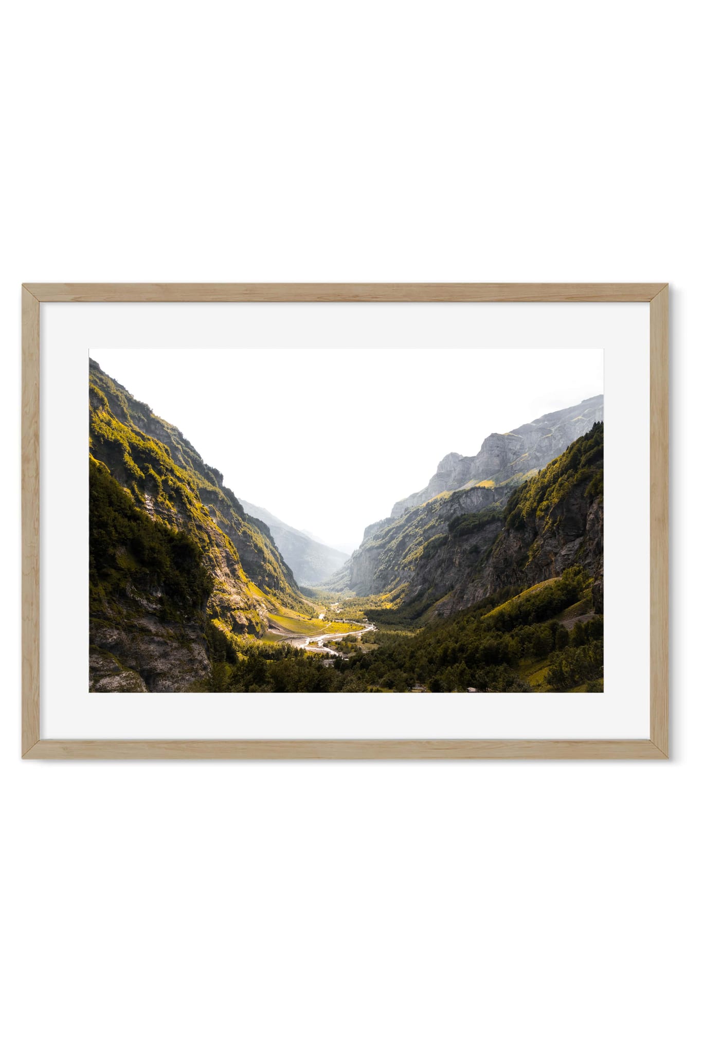 Wide alpine valley with a winding river and small village at sunrise