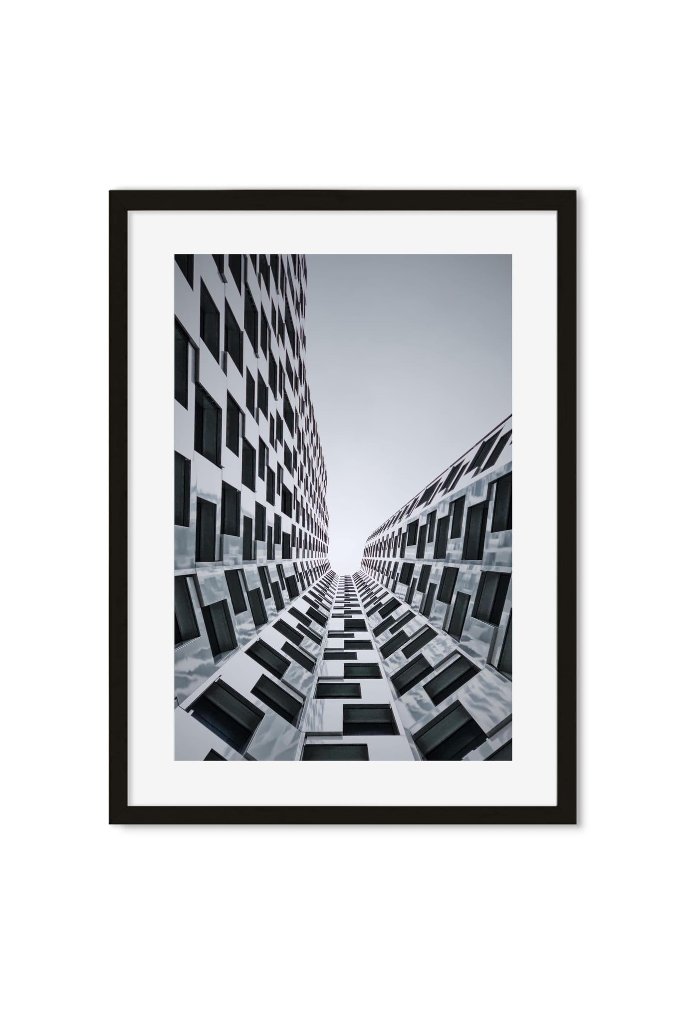 Upward view of two symmetric high-rise facades with a checkered window pattern