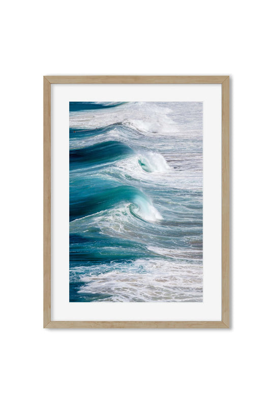 Framed poster of a close-up turquoise ocean wave breaking into foam