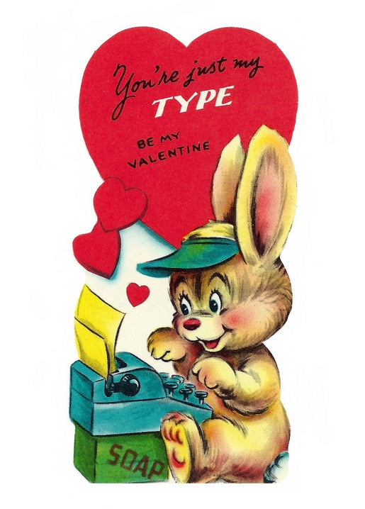 Vintage cartoon bunny typing on a typewriter set on a soap crate, with a 'You're Just My Type' heart