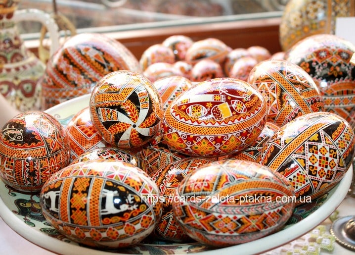 Haufen handbemalter ukrainischer Pysanky mit orange-schwarz-weißem Muster