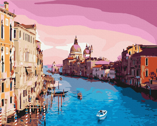 Venice's Grand Canal glowing pink and violet at sunset with boats