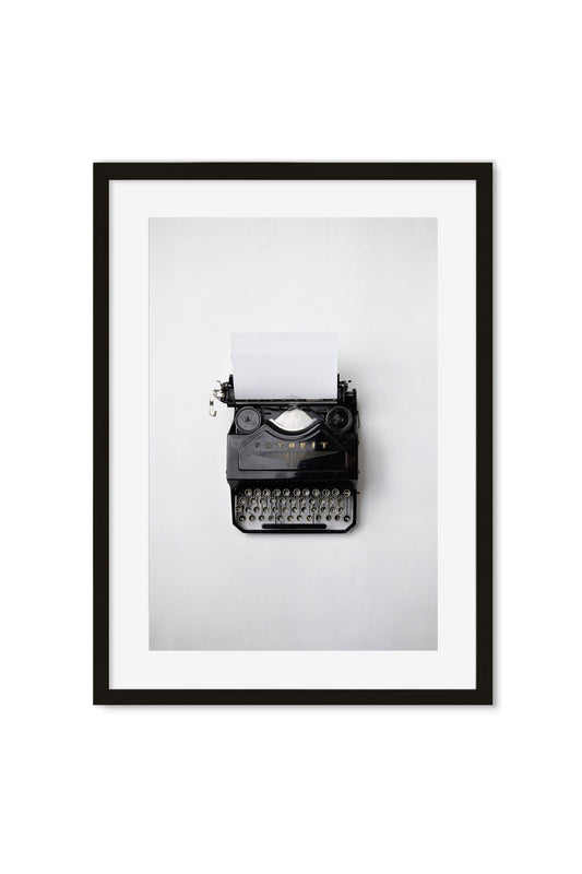 Black-and-white photo poster of a vintage typewriter with blank paper