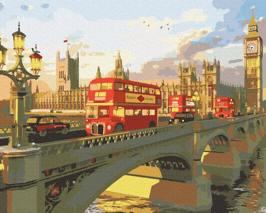 Red double-decker buses crossing Westminster Bridge at sunset with Big Ben glowing gold