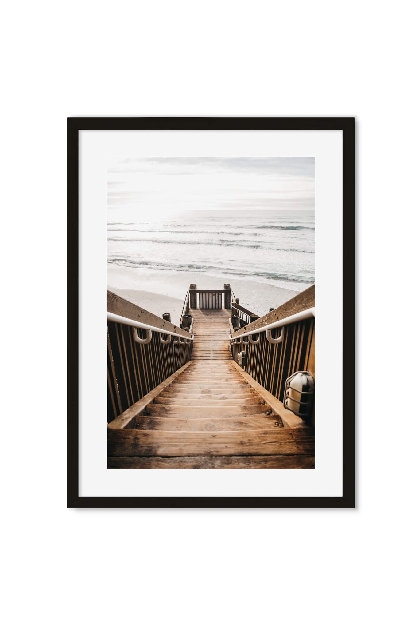 Framed poster of a wooden boardwalk stairway leading down to a sandy beach and ocean waves