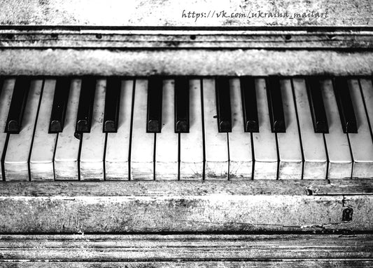 Black-and-white close-up of worn, weathered piano keys