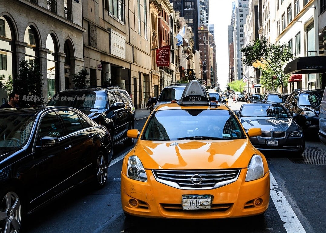 Yellow taxi cab stuck in traffic on a Manhattan street in New York